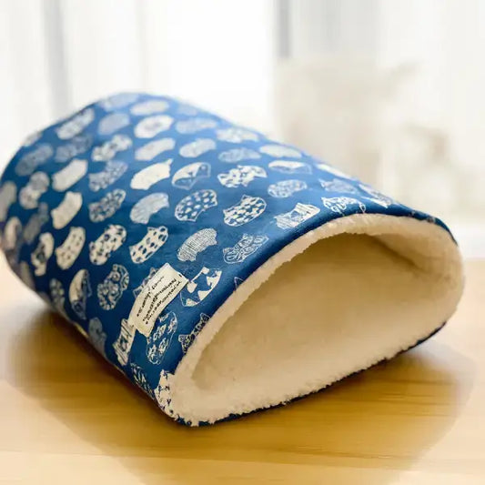 Close-up of patterned blue cat sleeping bag bed
