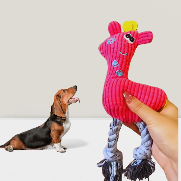 Dog excited by pink KnuffelGiraf plush dog toy with squeaker