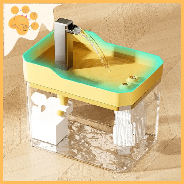 Automatic pet water fountain with yellow top, clear tank, and flowing water on wood floor