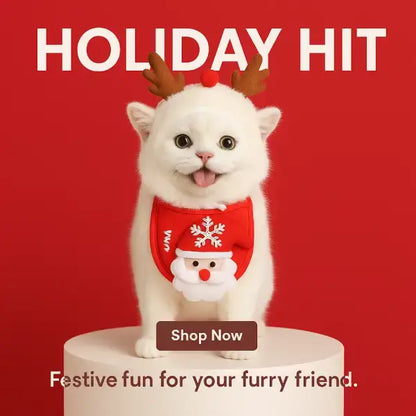 White cat in antler headband and Santa bib on red holiday backdrop, festive pet accessory