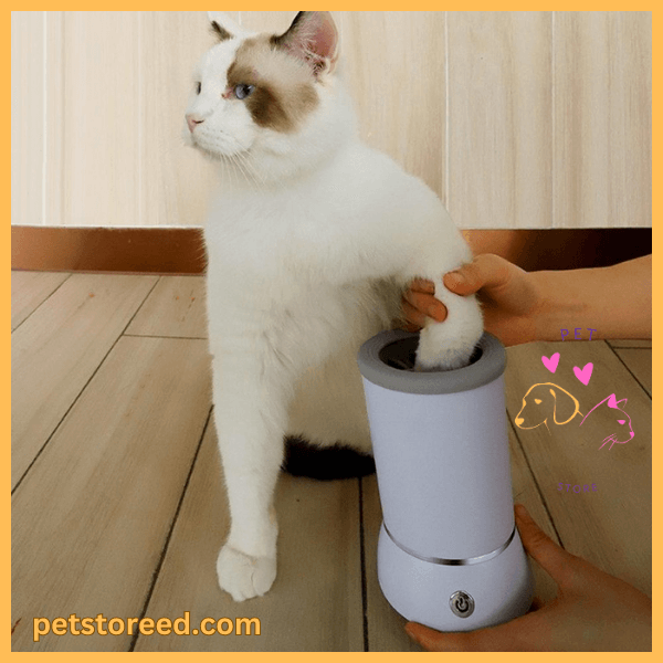 White cat using portable cat paw cleaner on wooden floor, pet care product demonstration