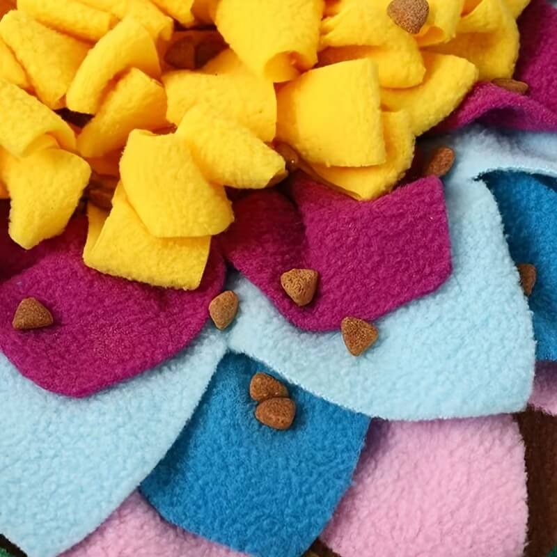 Kibble scattered across fleece layers of dog snuffle mat