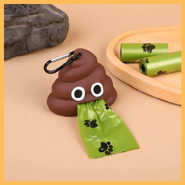 Cute poop-shaped dog waste bag holder with green paw print bags on table