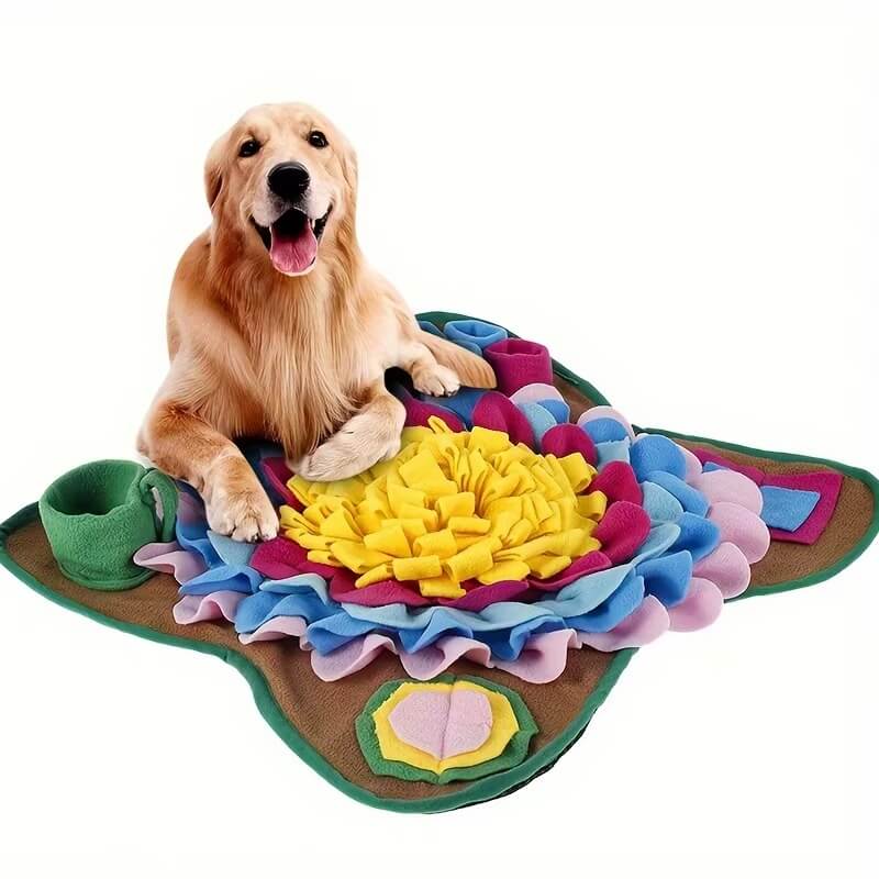 Dog lying beside flower-shaped snuffle mat for dogs
