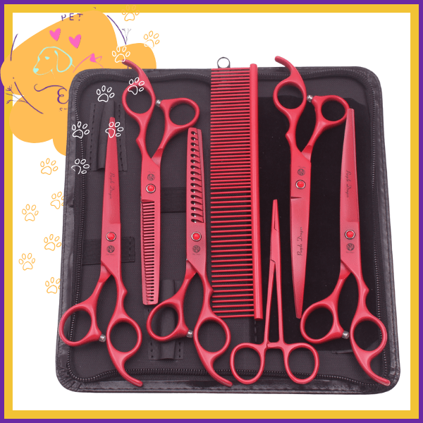 Red pet grooming shears set with scissors and comb in a black case, paw print background