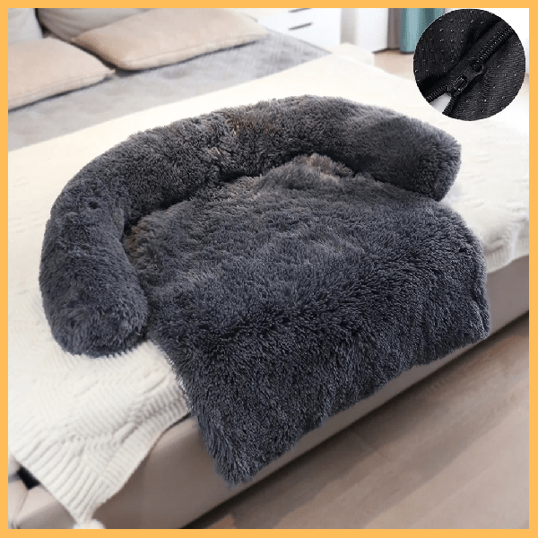 Fluffy dark gray dog blanket couch cover with bolster, displayed on a bed, close-up of zipper