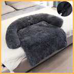 Fluffy dark gray dog blanket couch cover with bolster, displayed on a bed, close-up of zipper
