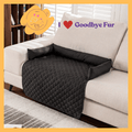 Black quilted pet sofa cover with bolstered sides on a beige couch, Goodbye Fur branding