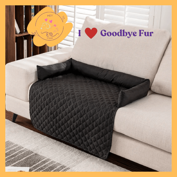 Black quilted pet sofa cover with bolstered sides on a beige couch, Goodbye Fur branding