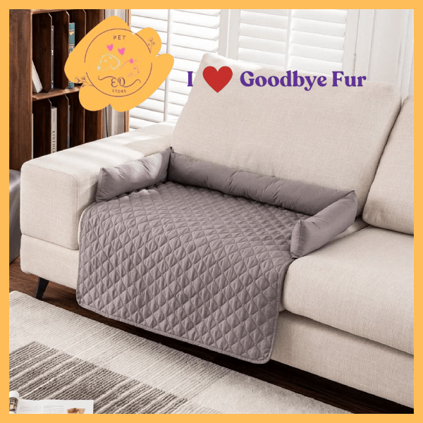 Grey quilted pet couch cover with bolster, on beige sofa, Goodbye Fur logo visible
