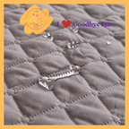 Waterproof quilted pet blanket with water droplets, Goodbye Fur branding and pet logo