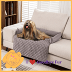 Long-haired dog relaxing on quilted Goodbye Fur sofa cover, luxury pet comfort product.