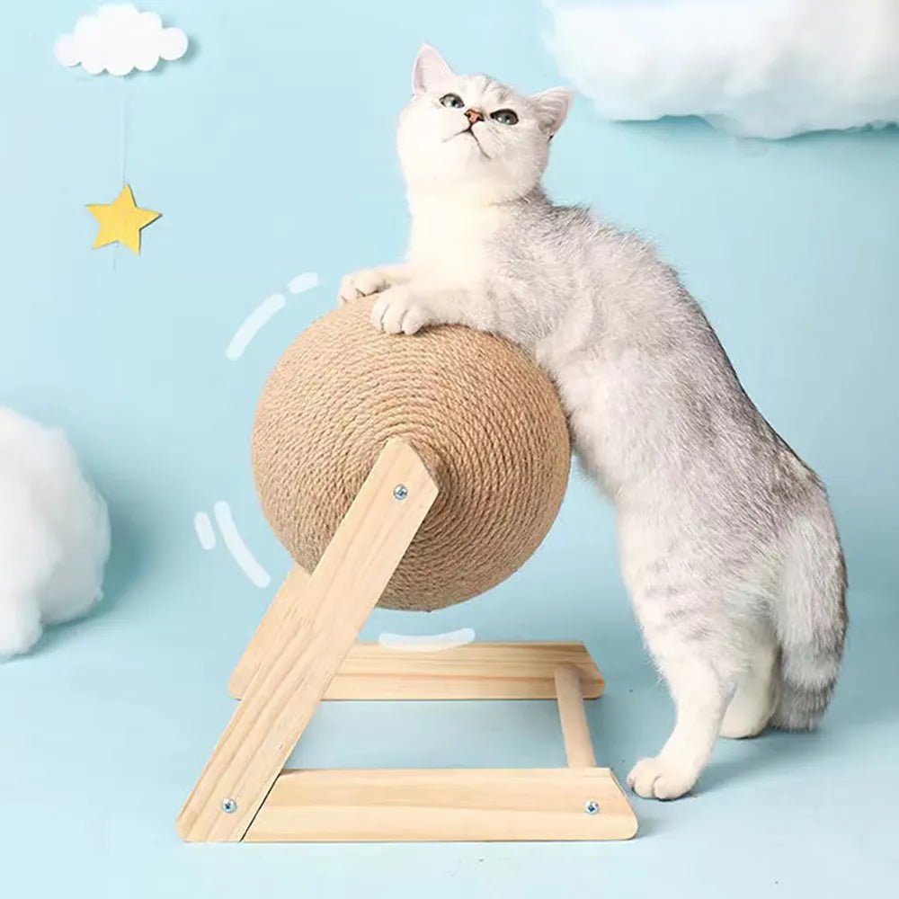 Gray cat using a sisal rope ball scratching post with wooden frame, blue background, clouds