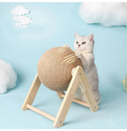 White cat playing with a spherical sisal cat scratching post on a wooden frame, blue background