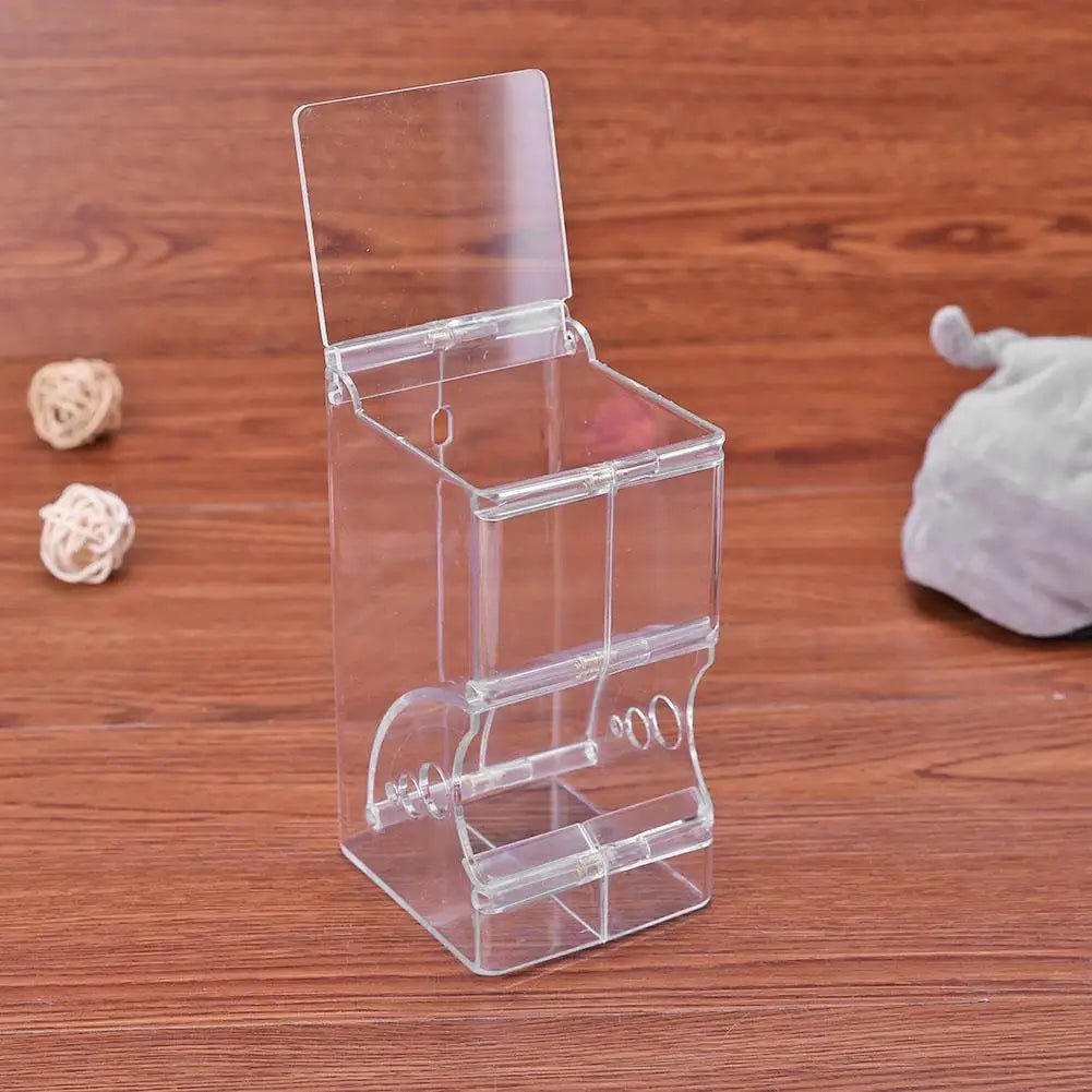 Clear acrylic dispenser box with lid on wooden table, pet food storage container