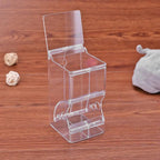 Clear acrylic dispenser box with lid on wooden table, pet food storage container