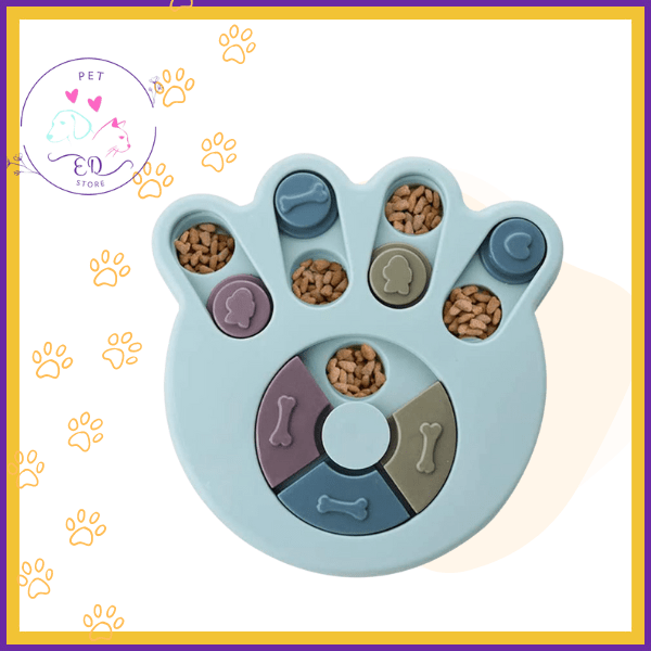 Blue interactive paw puzzle feeder for pets with kibble and sliding covers on white background
