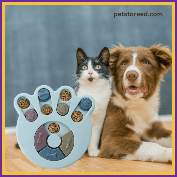 Cat and dog sitting beside interactive paw-shaped puzzle feeder with kibble, petstoreed.com