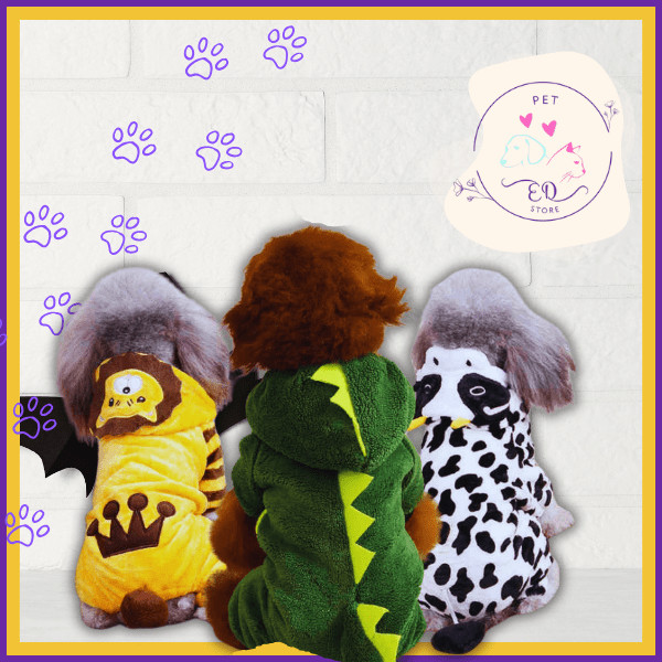 Three dogs in animal costumes, dragon, lion, and cow, sitting against a white brick wall