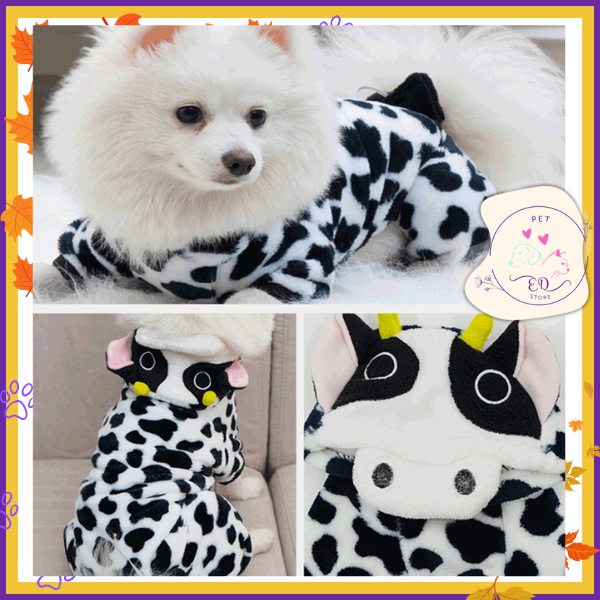 Small dog in a cozy faux cow print costume, demonstrating KnuffelWarm's winter pet fashion line