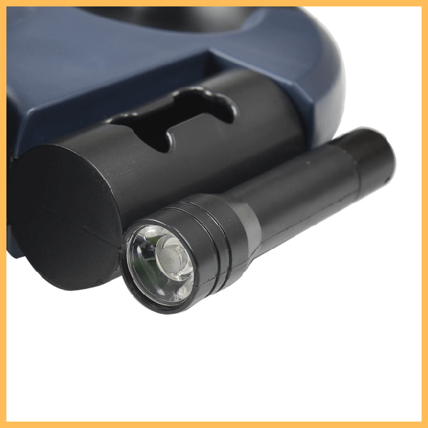 Black flashlight and mount attached to a dark blue device, close-up product photo