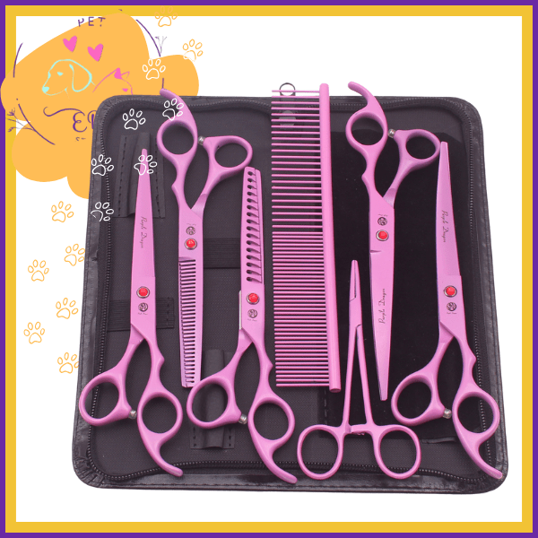 Pink pet grooming scissors and comb set in black case with paw print accents