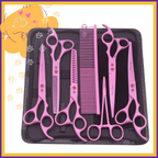 Pink pet grooming scissors and comb set in black case with paw print accents