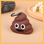 Poop emoji dog poop bag dispenser with carabiner on beige surface, flowers in background