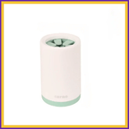 Portable green paw cleaner with soft bristles, white body, mint green base on white background