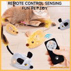 Cat plays with remote control plush mouse toy, hand holding remote on wooden floor.