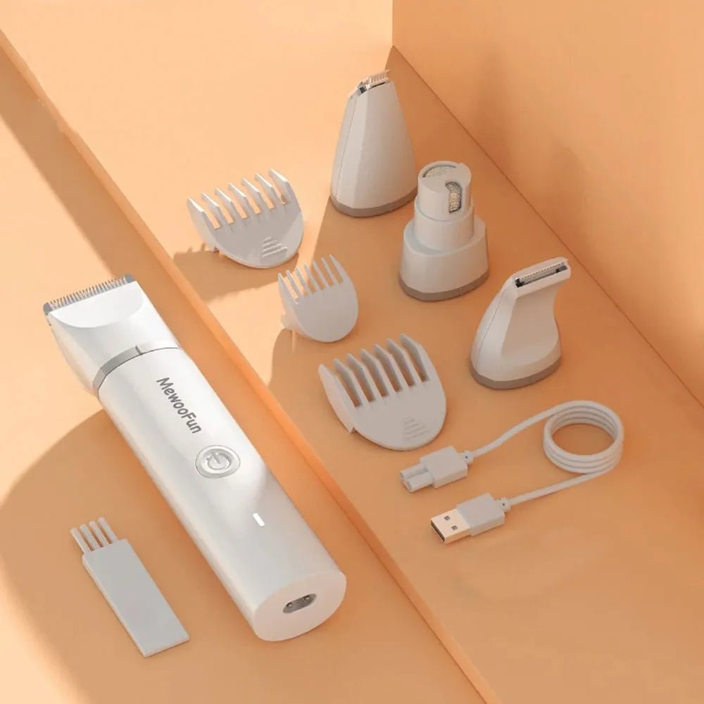 White electric hair trimmer kit with multiple clipper attachments and USB cable on peach background