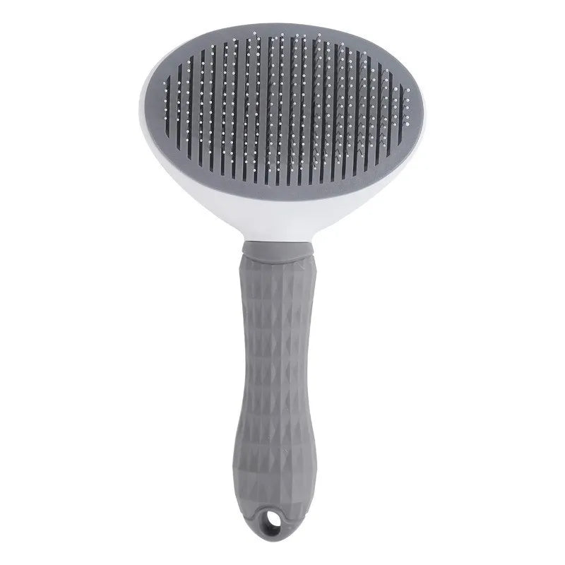 Gray pet grooming brush with textured handle and metal bristles on white background