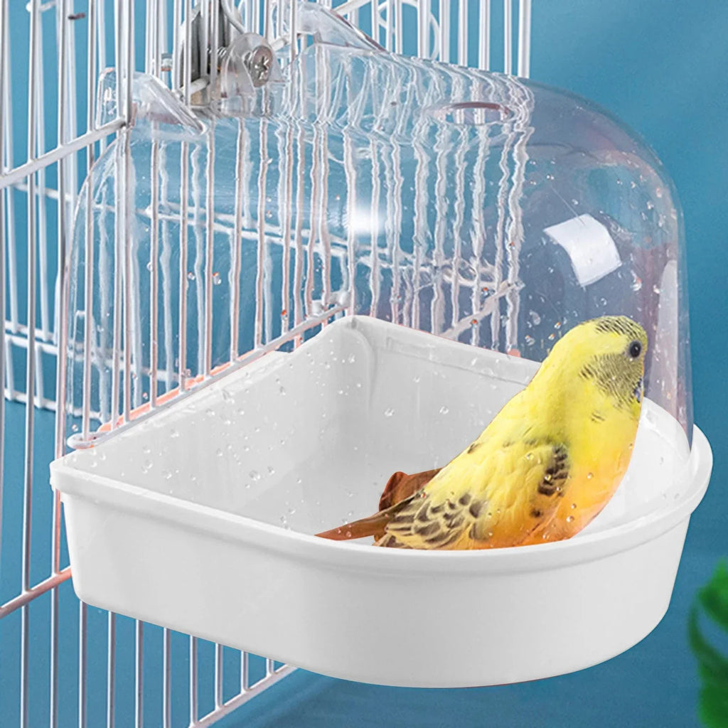 Yellow budgie in bird bath cage accessory with clear plastic cover