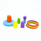 Colorful plastic ring toss game set with stackable pegs on a white background.