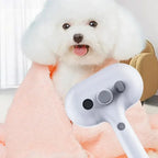 White fluffy dog wrapped in pink blanket with pet grooming dryer in foreground