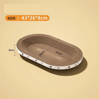 Oval cardboard cat scratcher bed, brown with cat print edge, size 43x26x8cm on beige background.
