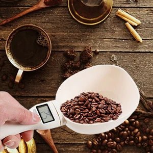 Digital spoon scale weighing coffee beans on rustic wooden table with coffee cup