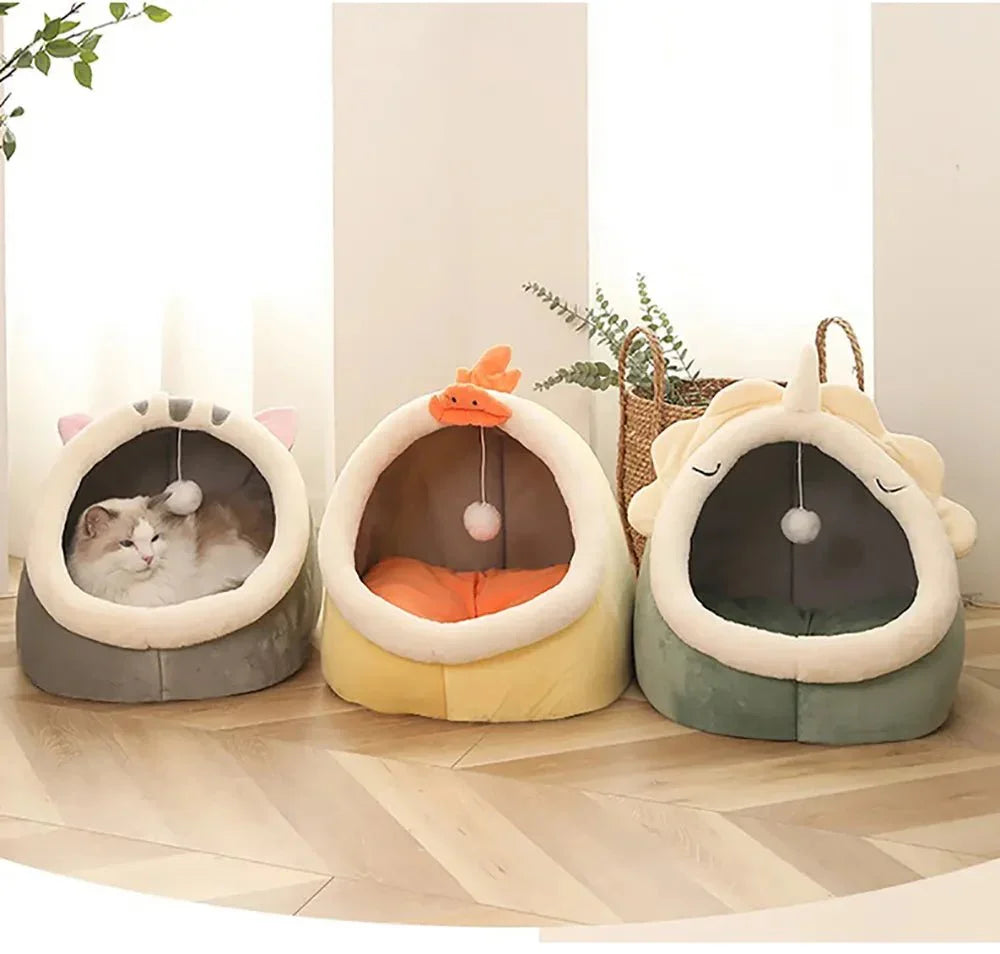Cute cat in a cozy animal-shaped pet bed with two empty plush cat beds beside it