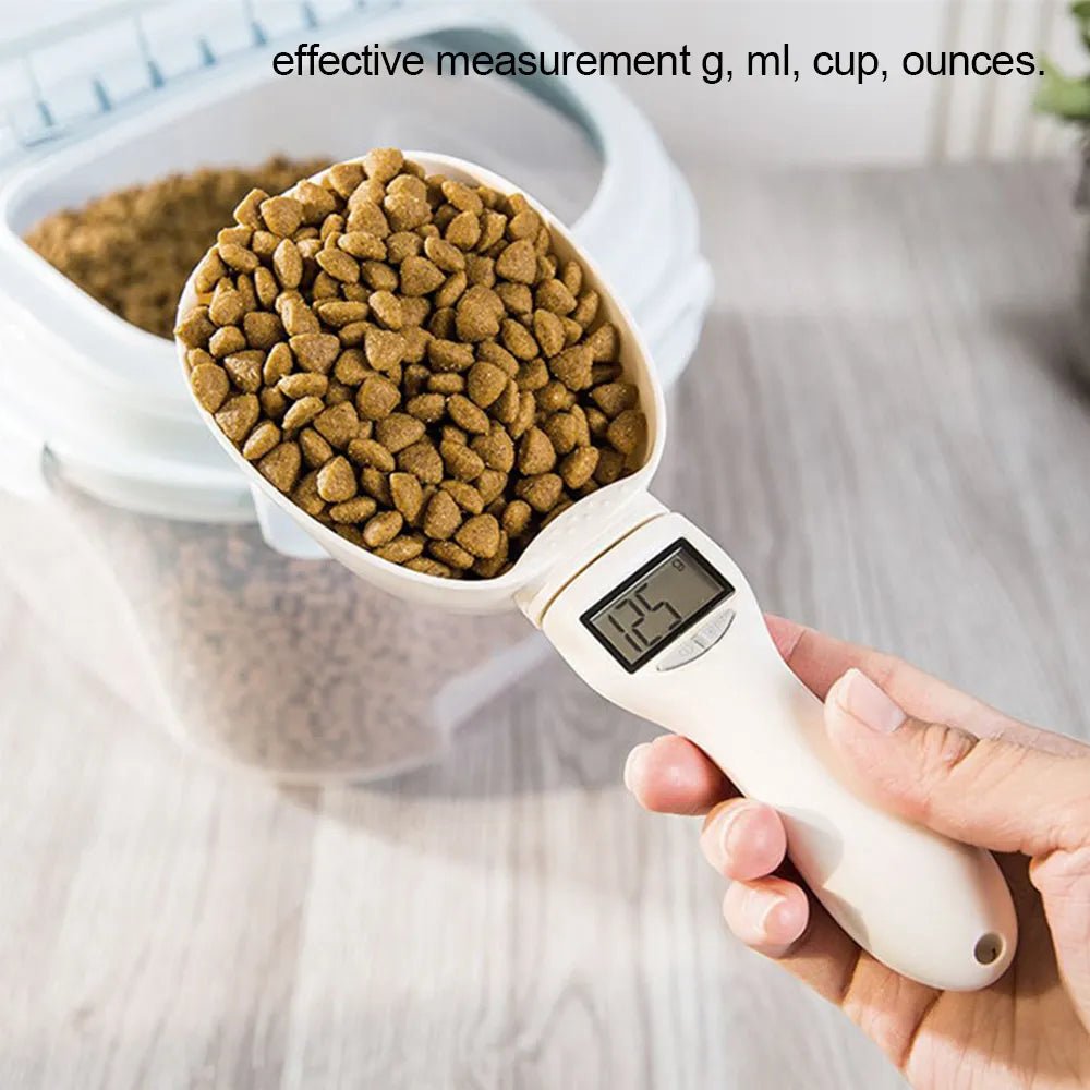 Digital pet food scoop with LCD display measuring dry kibble near storage container