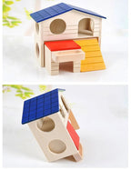 Wooden hamster house with blue roof, red platform, and yellow ramp on white background