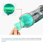 Portable vacuum with built-in garbage bag storage in teal color being dispensed by hand