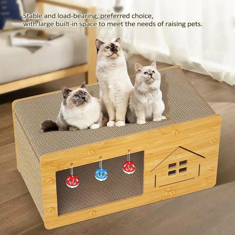Three cats sitting on a wooden cat scratcher house with hanging toys, indoor pet furniture