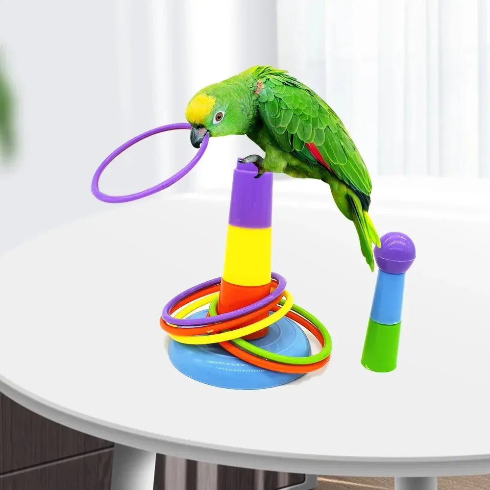 Green parrot playing with colorful plastic ring toss toy on a white table indoors