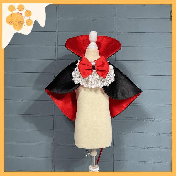Vampire cape for pets with red and black satin fabric, lace collar, and red bow on mannequin
