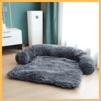 Plush gray dog bed for all breeds in a modern bedroom by a window