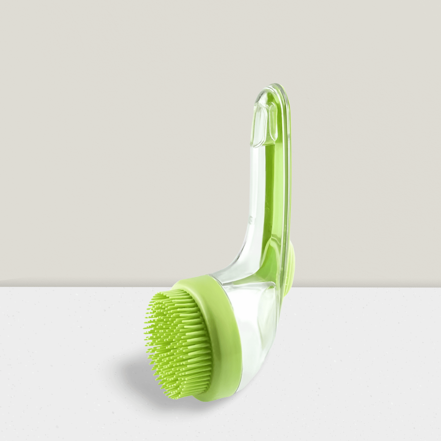 Green pet bath brush with silicone bristles and clear handle on light background