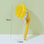 Yellow pet bath brush with handle, dog grooming tool, 18cm x 7.5cm, on light background