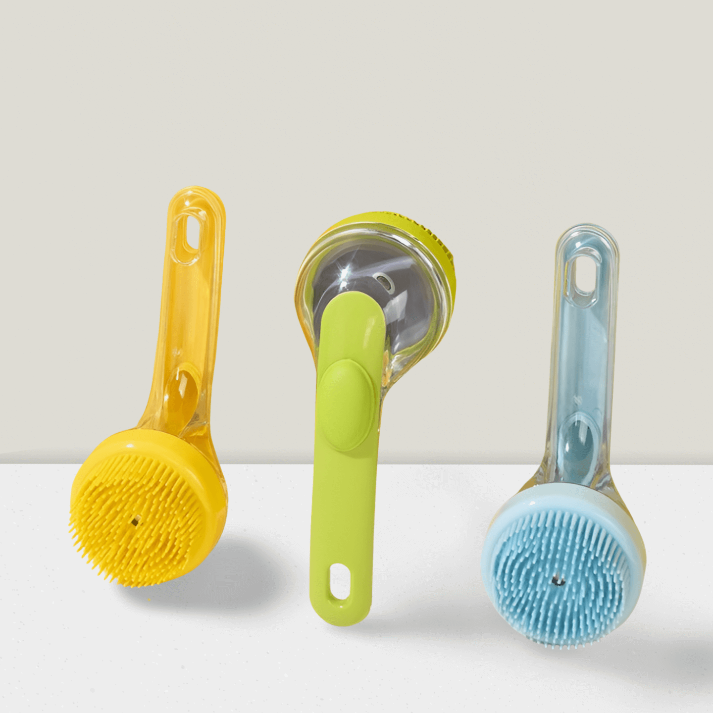 Blue and yellow silicone pet bath brushes with handles displayed on white surface