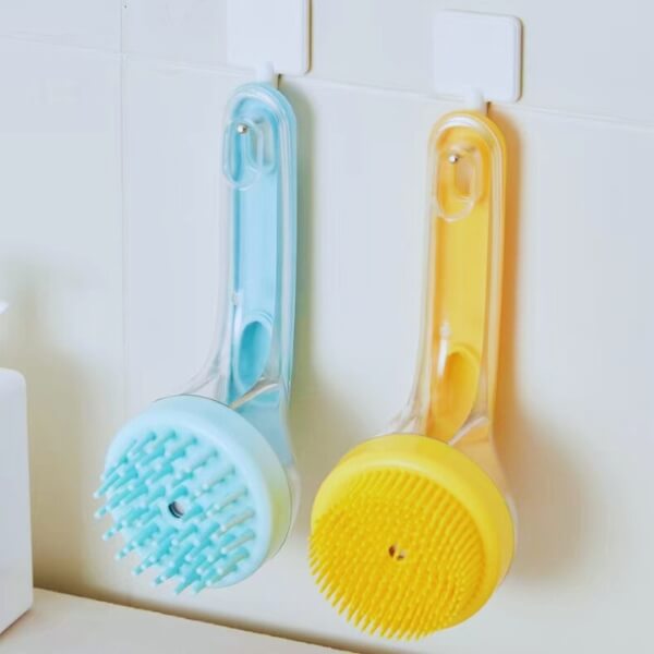 Blue and yellow pet bath brushes with soft bristles hanging on hooks in a bathroom