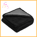 Folded black waterproof dog blanket with soft texture on white background